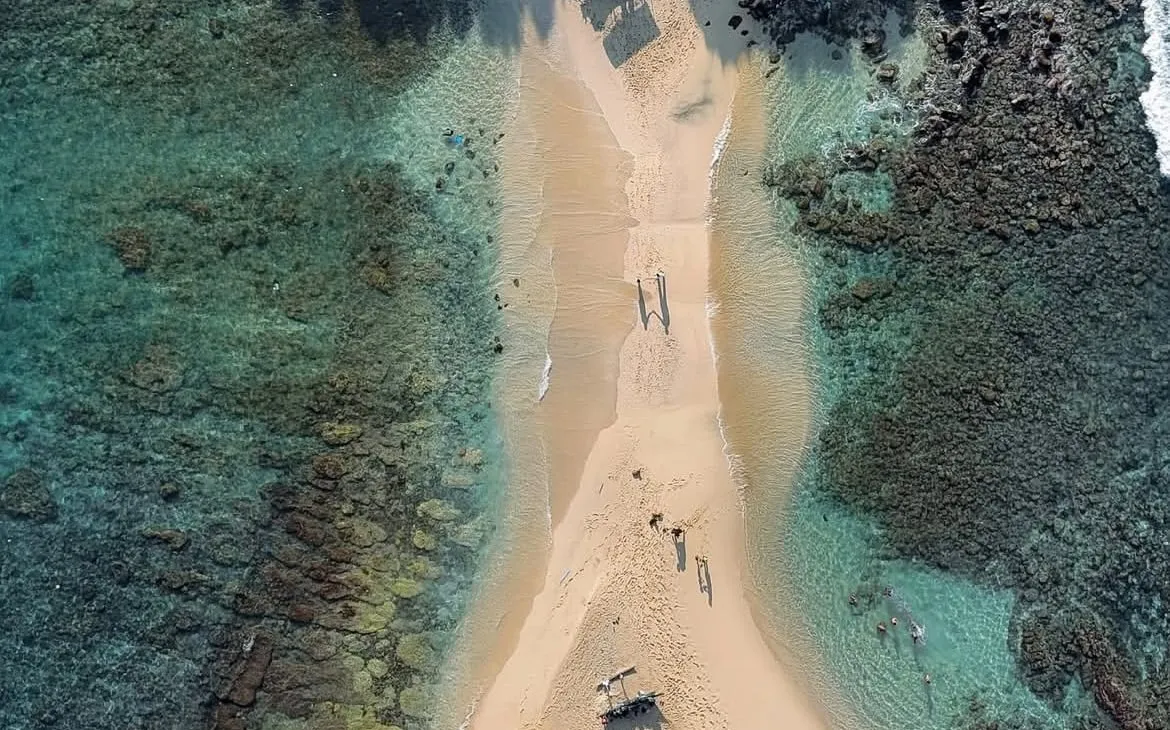 The sandbar out to Blue Beach Island from straight above, with reef and clear water on both sides