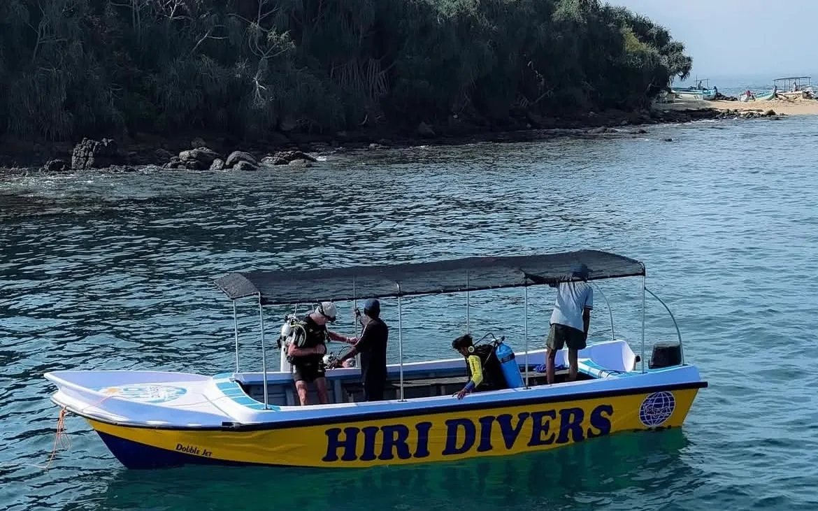 The Hiri Divers boat with divers getting ready, off Blue Beach Island